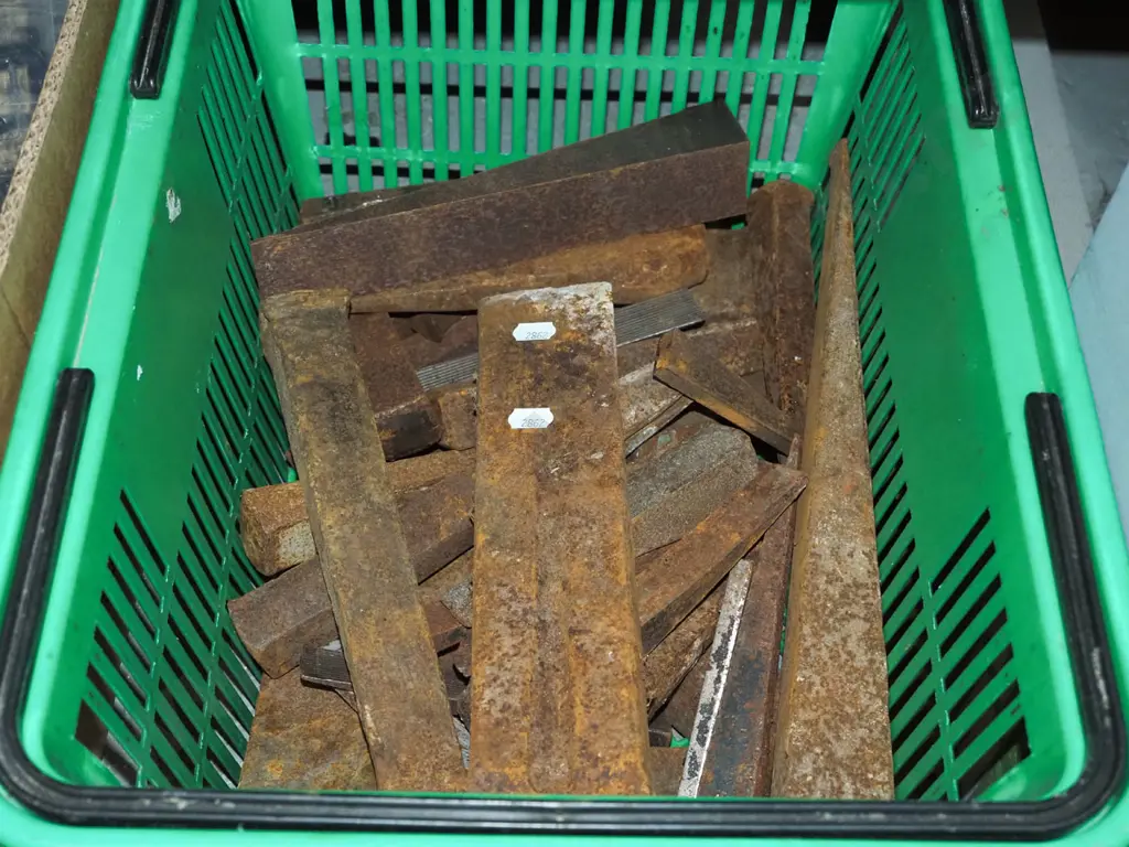 plastic basket of rusty metal wedges Image 1++