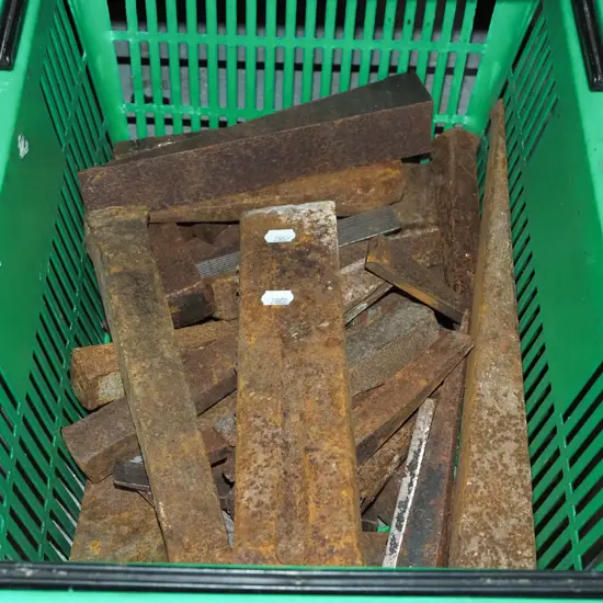 plastic basket of rusty metal wedges