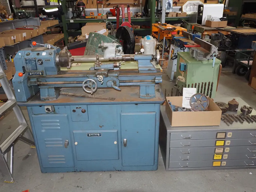 Boxford metal workers lathe with accessories and parts - on top of metal plan drawers Image 1++