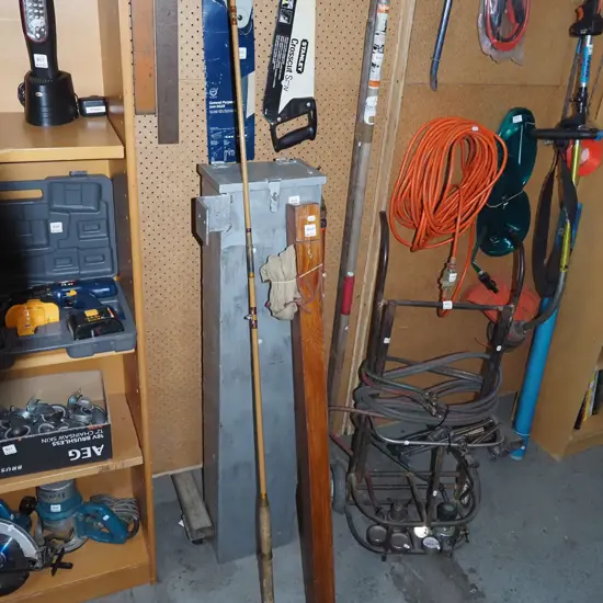 vintage fishing rod with canvas cover and wooden carry box
