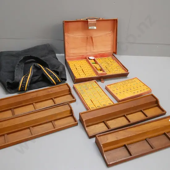 vintage leather-cased Mahjong set with lift-out trays, manufacturer marked on latch and case, plus 4 teak tile trays.