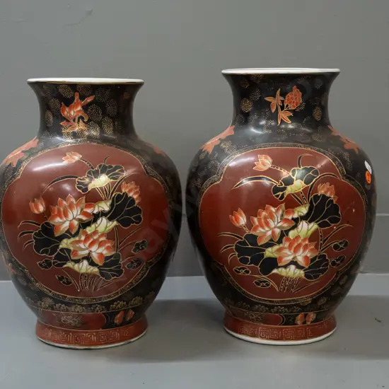 pair of Chinese bolster-shaped vases with floral decoration and gilt highlights - chipping to base of one, some