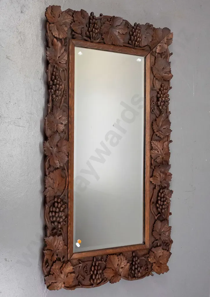 vintage carved oak-framed bevelled edge mirror profusely carved with grape and leaf motifs, chips and a small Image 1++