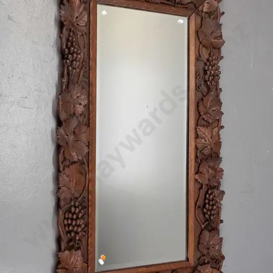 vintage carved oak-framed bevelled edge mirror profusely carved with grape and leaf motifs, chips and a small