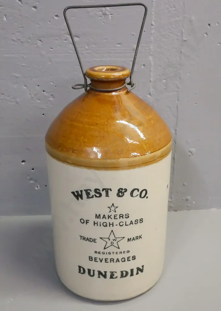 Stonewear crock marked Timaru for West & Co Beverages Dunedin. With wire handle, missing stopper. H-330 D-160 Image 1++