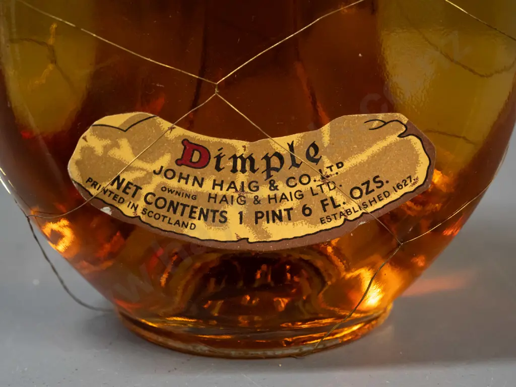 vintage bottle of John Haig & Co "Dimple" scotch whisky - dimpled bottle with mesh cover - 1 pint 6 ounce (approx 700ml) Image 1++
