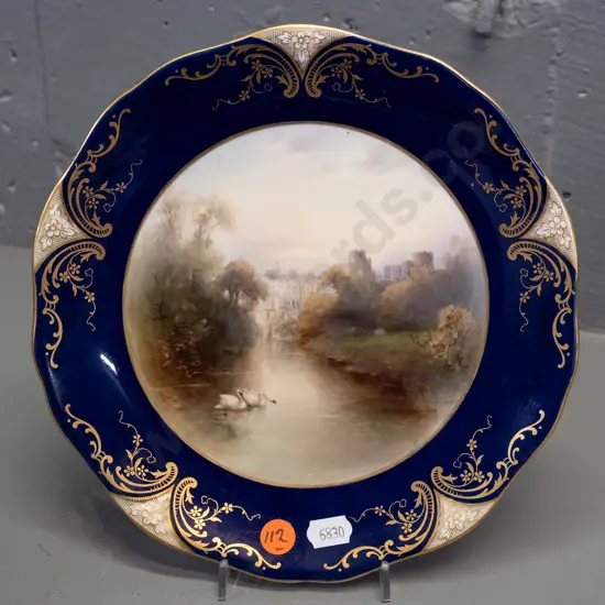Royal Worcester cabinet plate with gilt rim, swans on river with city (Edinburgh?) scene - signed Harry Stinton, circa