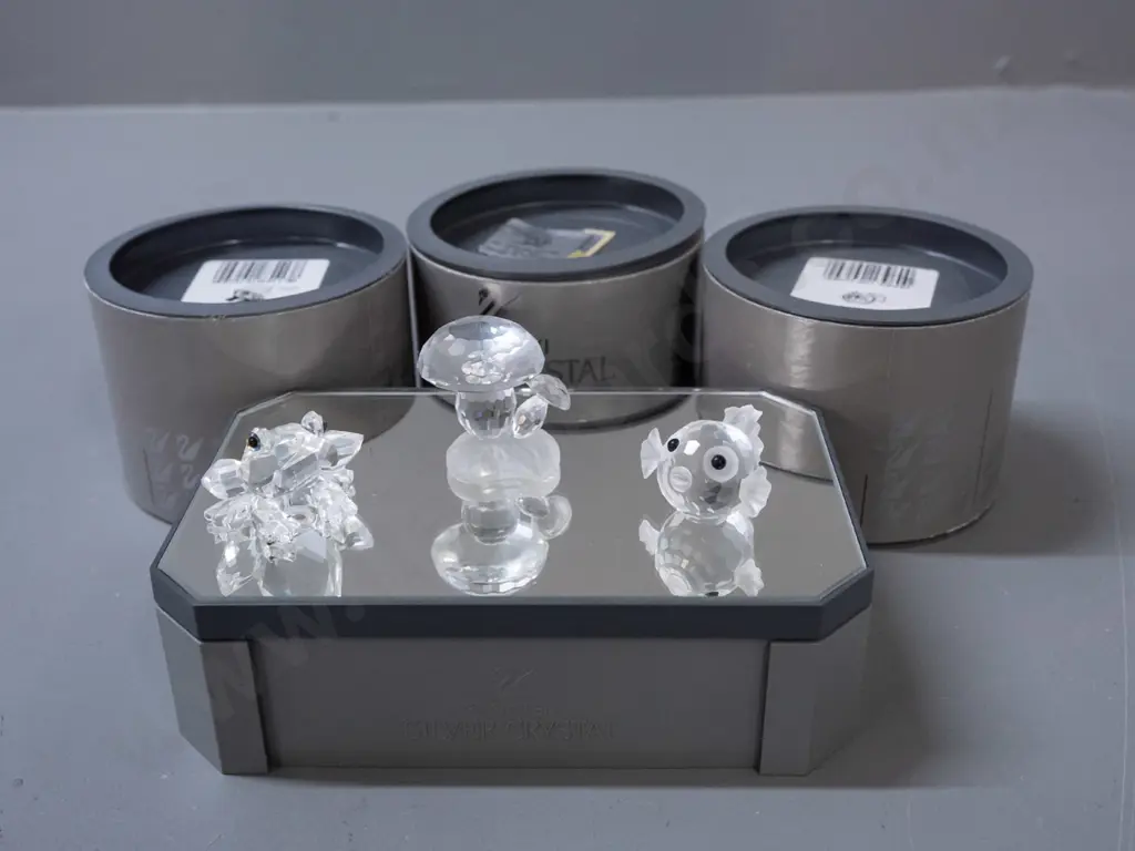 3 Swarovski crystal miniature figurines on mirrored display stand - frog, puffer fish, mushroom H-40, stand W-140. Image 1++