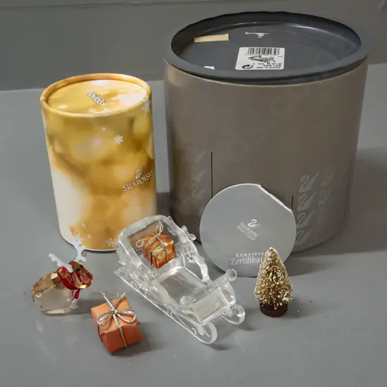 Swarovski crystal Christmas themed ornaments - sleigh set with presents & tree and a small reindeer, both with original