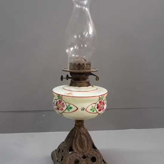vintage kerosene lamp with hand painted uranium glass tank on cast metal base, globe logo on adjustment knobs H-555