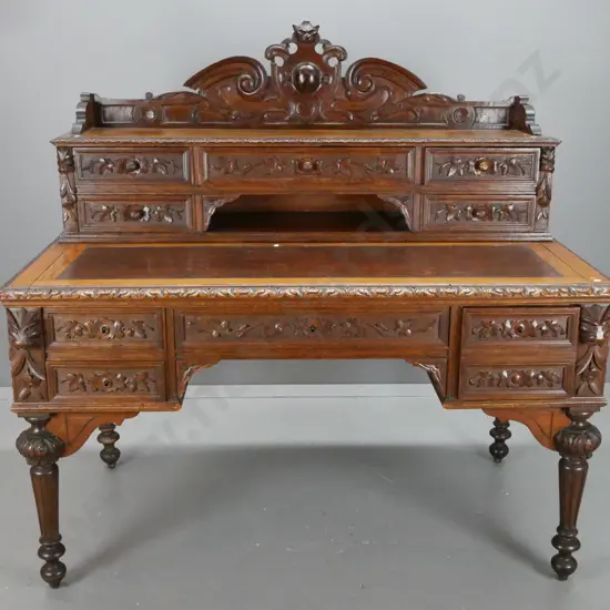 antique French 1870s oak desk with carved lion's head crest and corbels, 5 drawer bank in top, slide-out writing surface