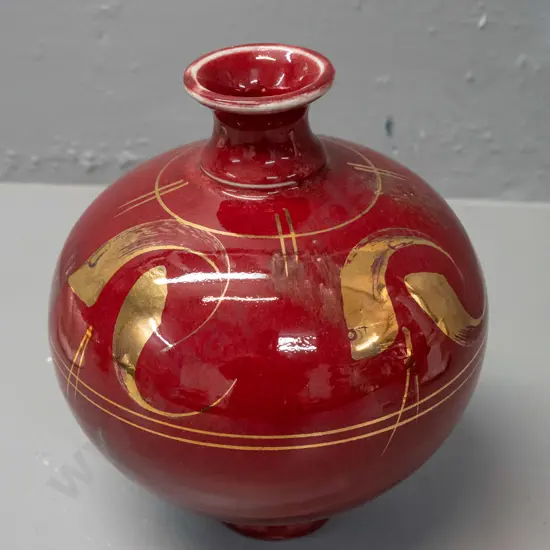 Paul Laird New Zealand studio pottery bottle vase - gilt decoration over dark red, label marked Whirling Dervish Bottle