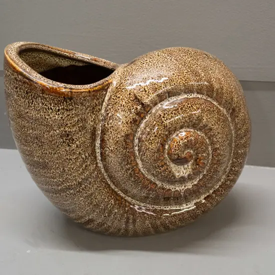 nautilus shell vase in mottled brown glaze, no maker's marks H-180 L-250