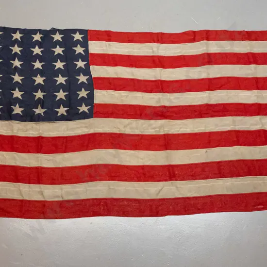 vintage "Stars and Stripes" U.S. flag with rope and toggle - a tear at top, some repairs, fraying &
