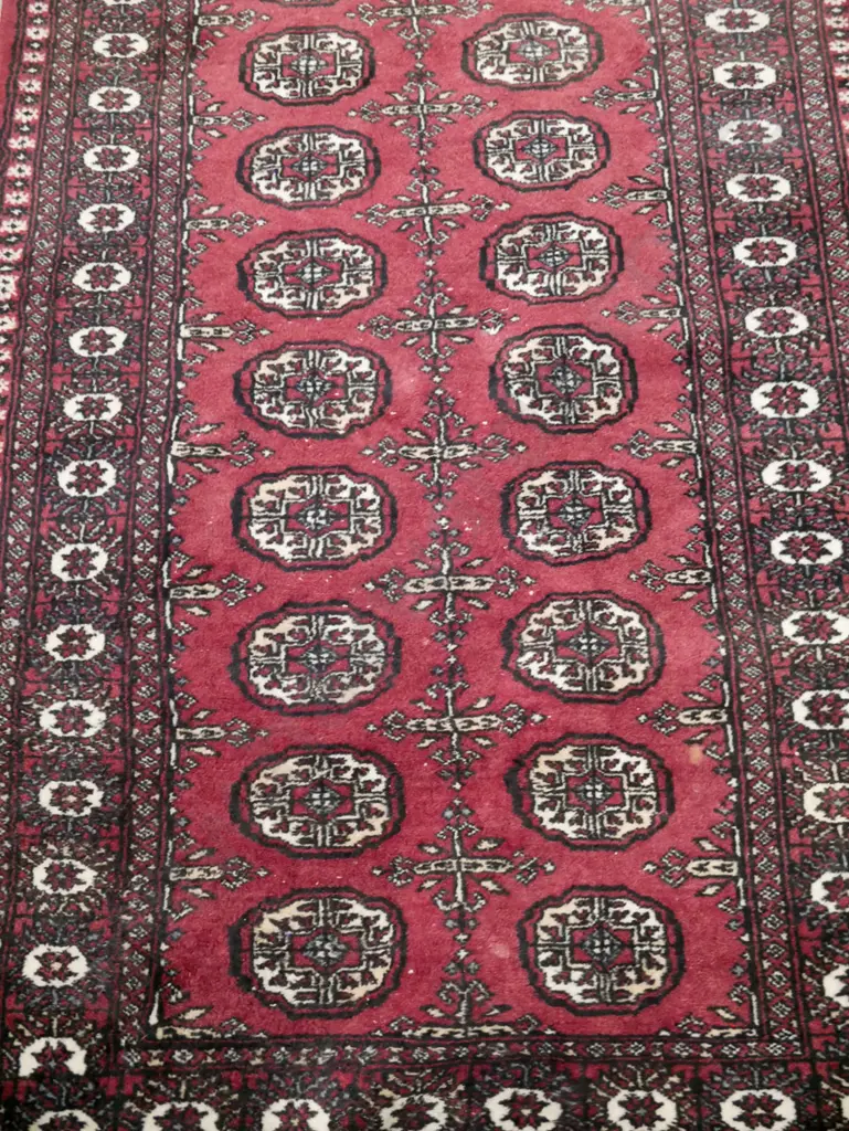 Pakistani hand-knotted wool Turkoman style floor rug in dark reds, black and ivory - some wear & spots of loss to pile. Image 1++