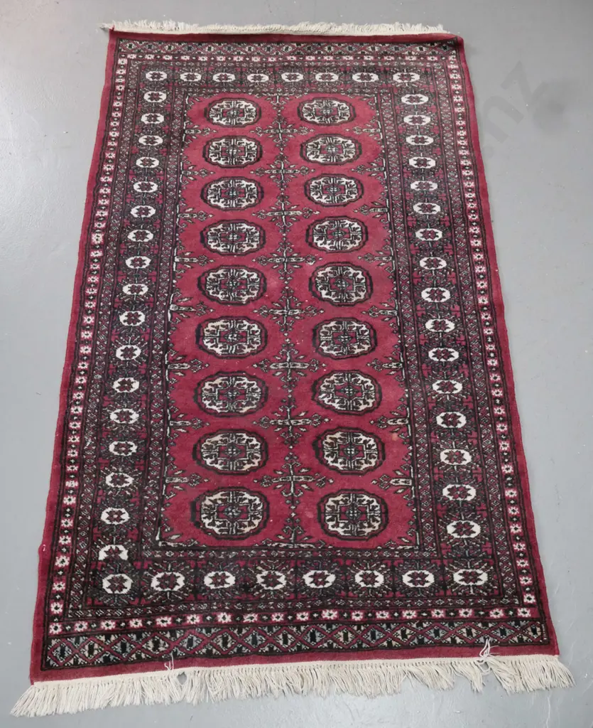 Pakistani hand-knotted wool Turkoman style floor rug in dark reds, black and ivory - some wear & spots of loss to pile. Image 1++