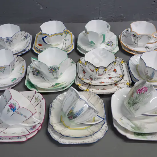 group of Shelley deco-style trios in different patterns & colours, matching scalloped facet-sided cup shape