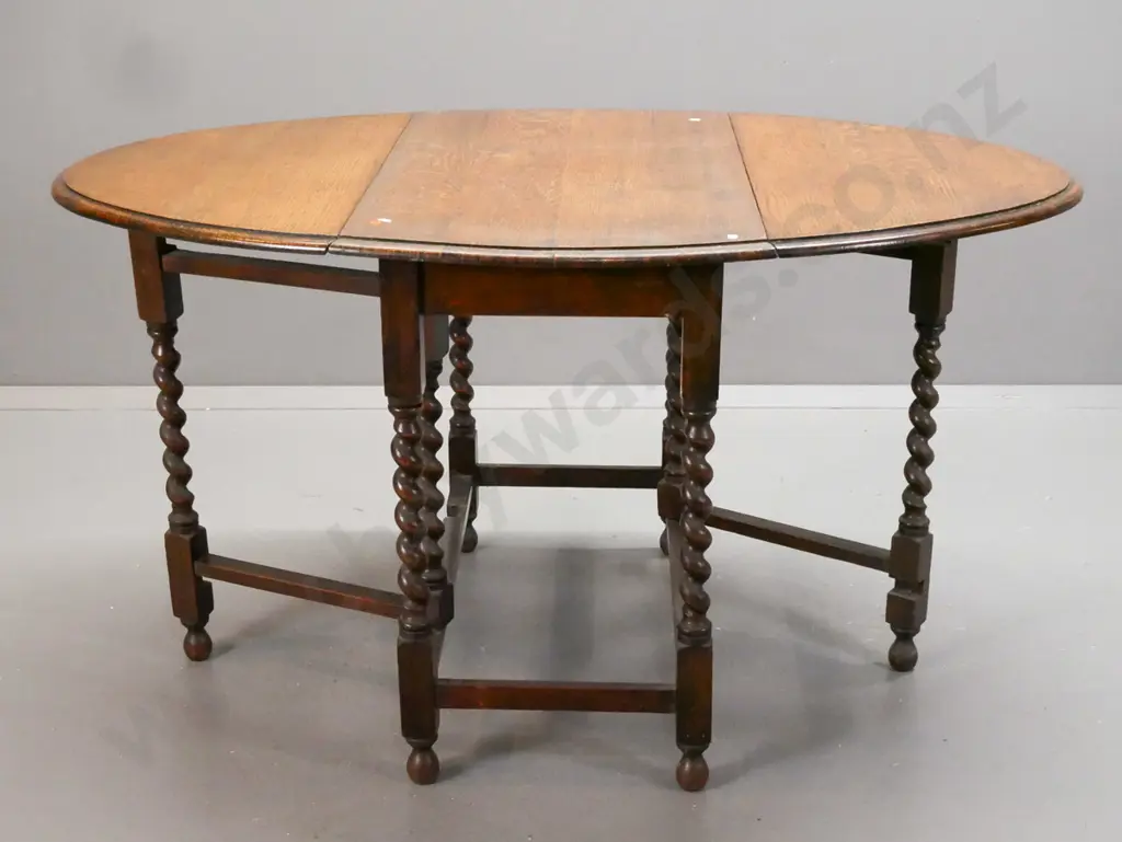 vintage oak oval gate-leg table w/ jacobean twist leg supports, rectangular refectory-style base on bobbin-tuned feet. Image 1++