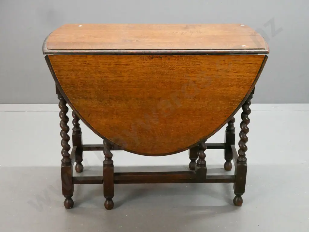 vintage oak oval gate-leg table w/ jacobean twist leg supports, rectangular refectory-style base on bobbin-tuned feet. Image 1++