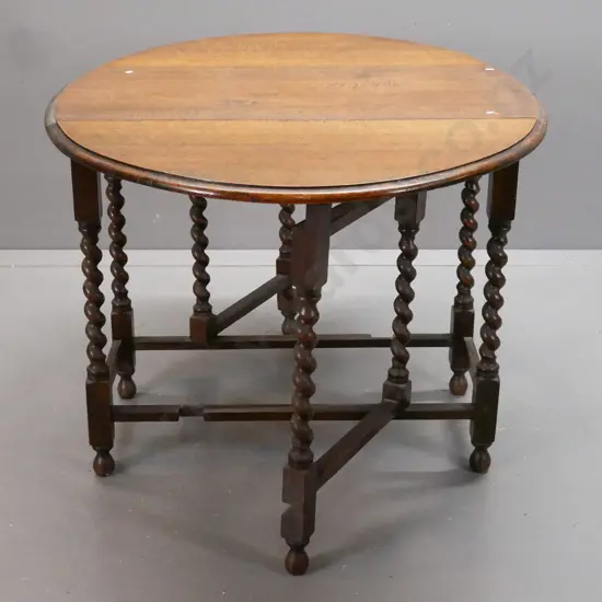 vintage oak oval gate-leg table w/ jacobean twist leg supports, rectangular refectory-style base on bobbin-tuned feet.