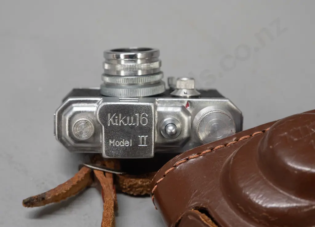 vintage Japanese "Kiku 16 Model II" miniature camera with leather case. Has take-up spool, shutter fires intermittently, Image 1++