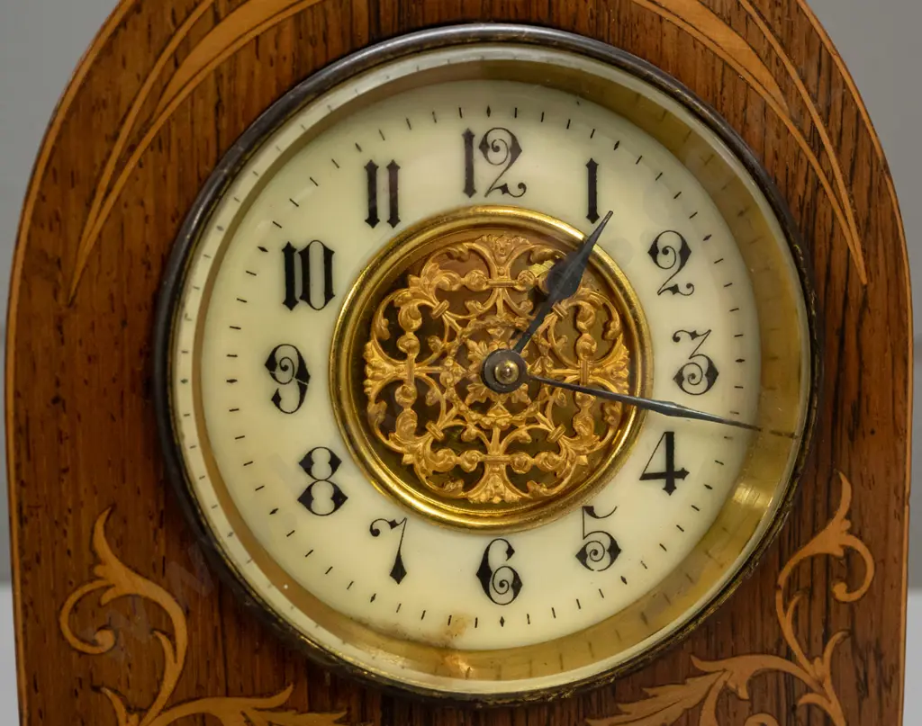 vintage mantel clock in arched rosewood case with boxwood and harewood stringing and inlays, porcelain face with pierced Image 1++