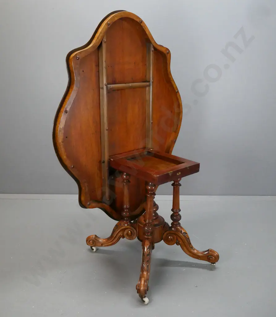 Victorian walnut centre table with serpentine shaped top on 4-point cathedral base on scrolling feet with porcelain Image 1++