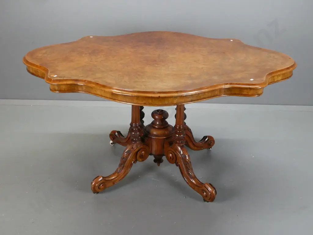 Victorian walnut centre table with serpentine shaped top on 4-point cathedral base on scrolling feet with porcelain Image 1++