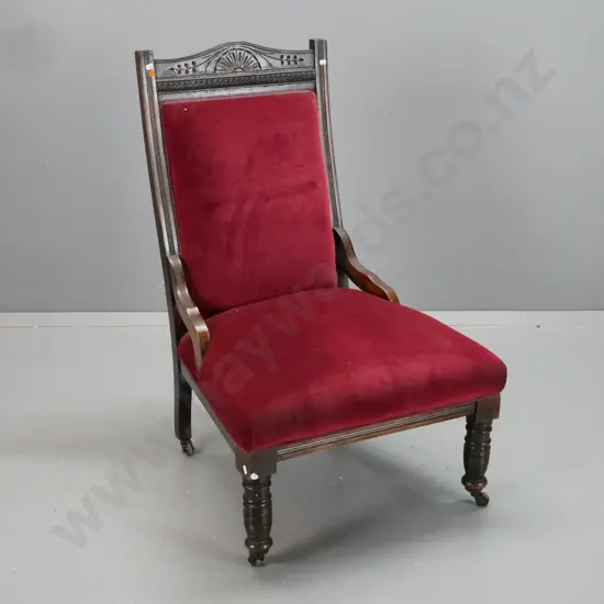 Edwardian beech fireside chair carved crest top rail, pressed swirling coin decoration, turned front legs on porcelain