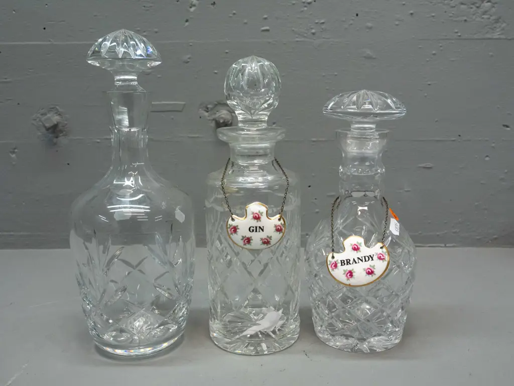 3 cut crystal stoppered decanters and 2 Royal Adderley / Ridgway "Gin" and "Brandy" porcelain labels - tallest is H-290 Image 1++