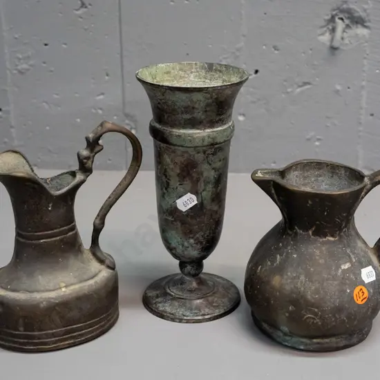 2 heavy cast brass jugs and a patina'd metal footed vase H-200