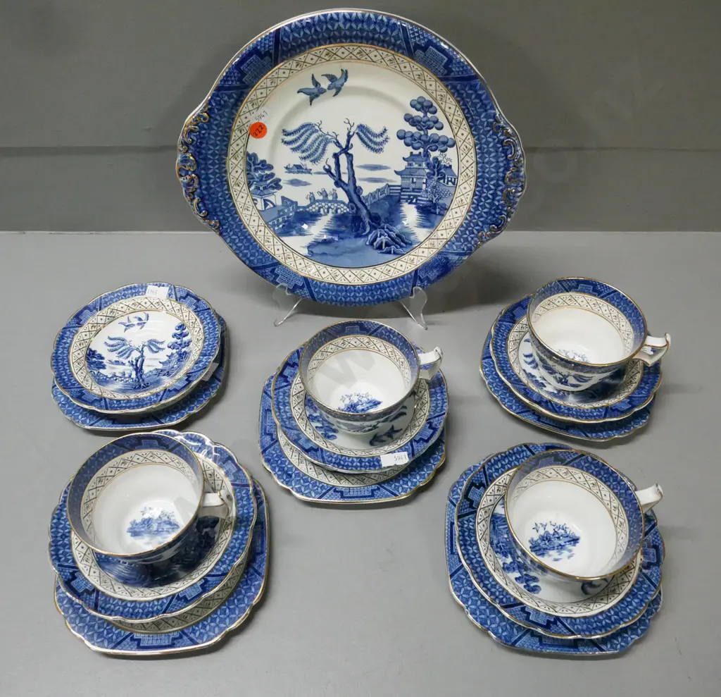 Booths 'Real Old Willow' gilt-finished blue-and-white teaware: 4x trios & cake plate, extra plate & saucer (w/ chip). Image 1++