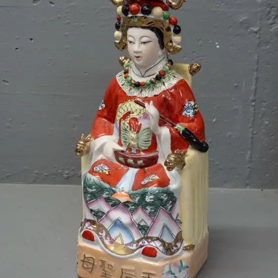 Chinese seated figure - hand painted porcelain with gilded highlights and script across base, no maker's marks H-340