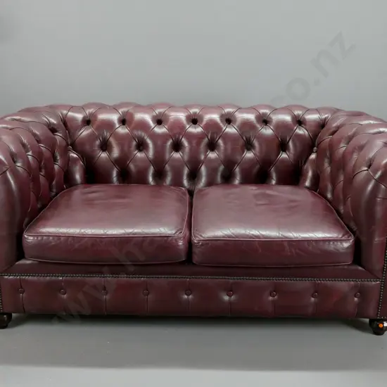 dark burgundy leather 2-seater rolled arm deep-button settee with domed front trim, 2 pop-out seat cushions - some wear