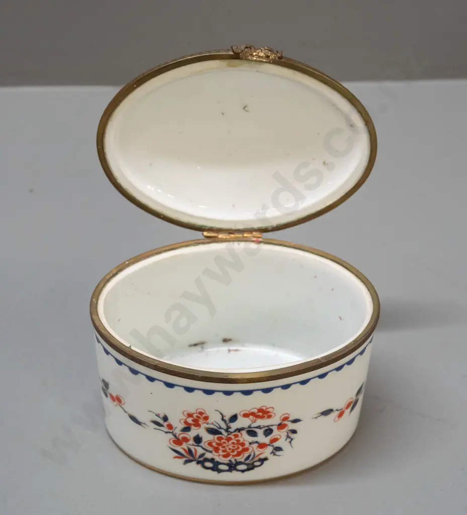 vintage lidded porcelain oval casket with cast brass fittings, gilt bottom rim. Porcelain de France mark and label, lid Image 1++