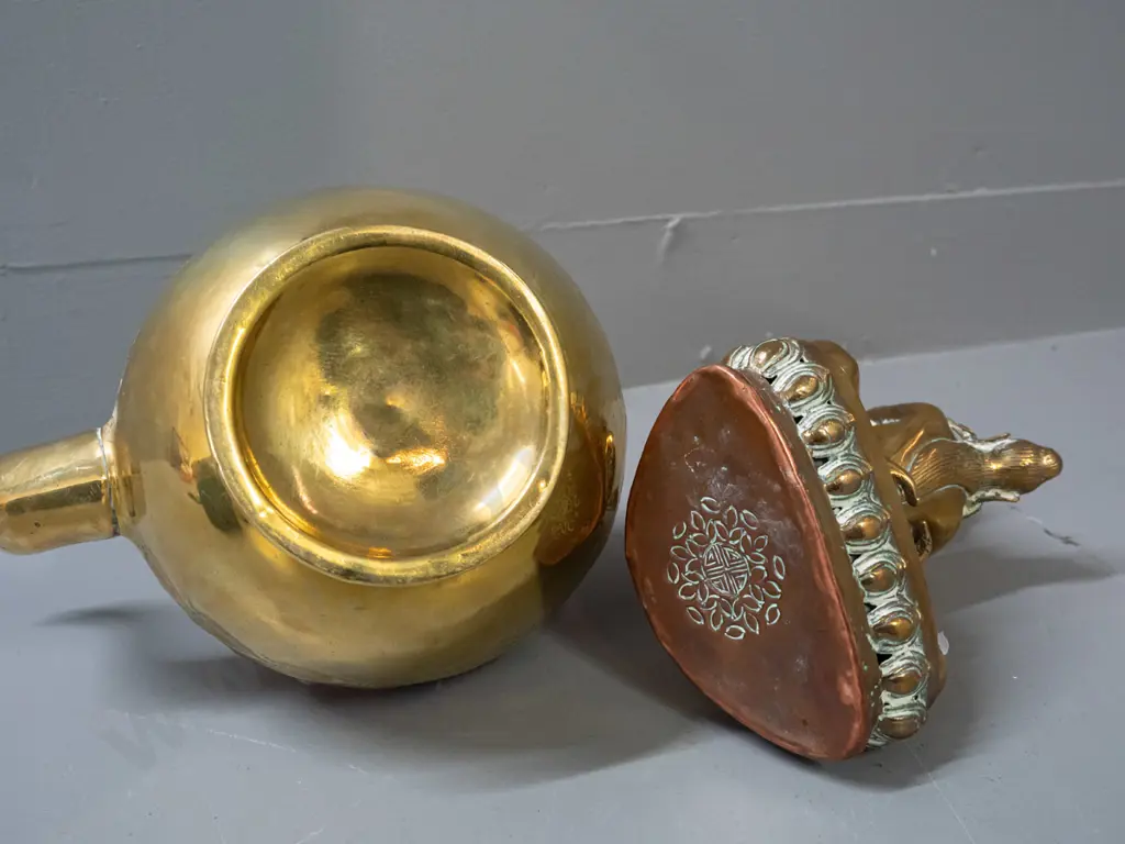 brass teapot with turned wood handle, band of pressed copper decoration, brass-plated lid, and brass erotic figure with Image 1++