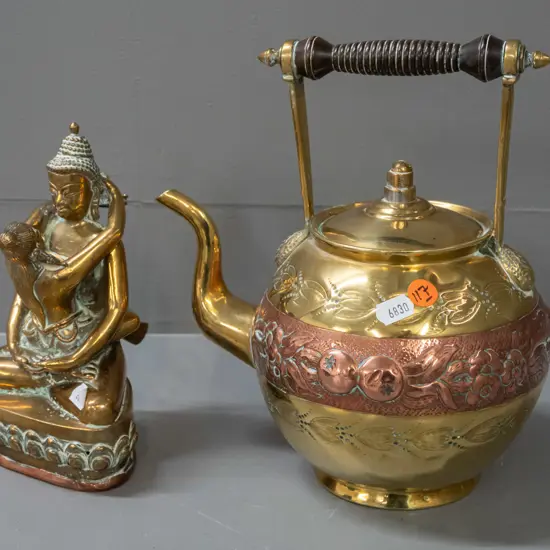 brass teapot with turned wood handle, band of pressed copper decoration, brass-plated lid, and brass erotic figure with