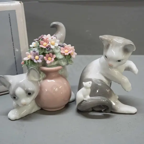 2 LLadro cat figurines, one with original box - one with pot of flowers H-90 W-110