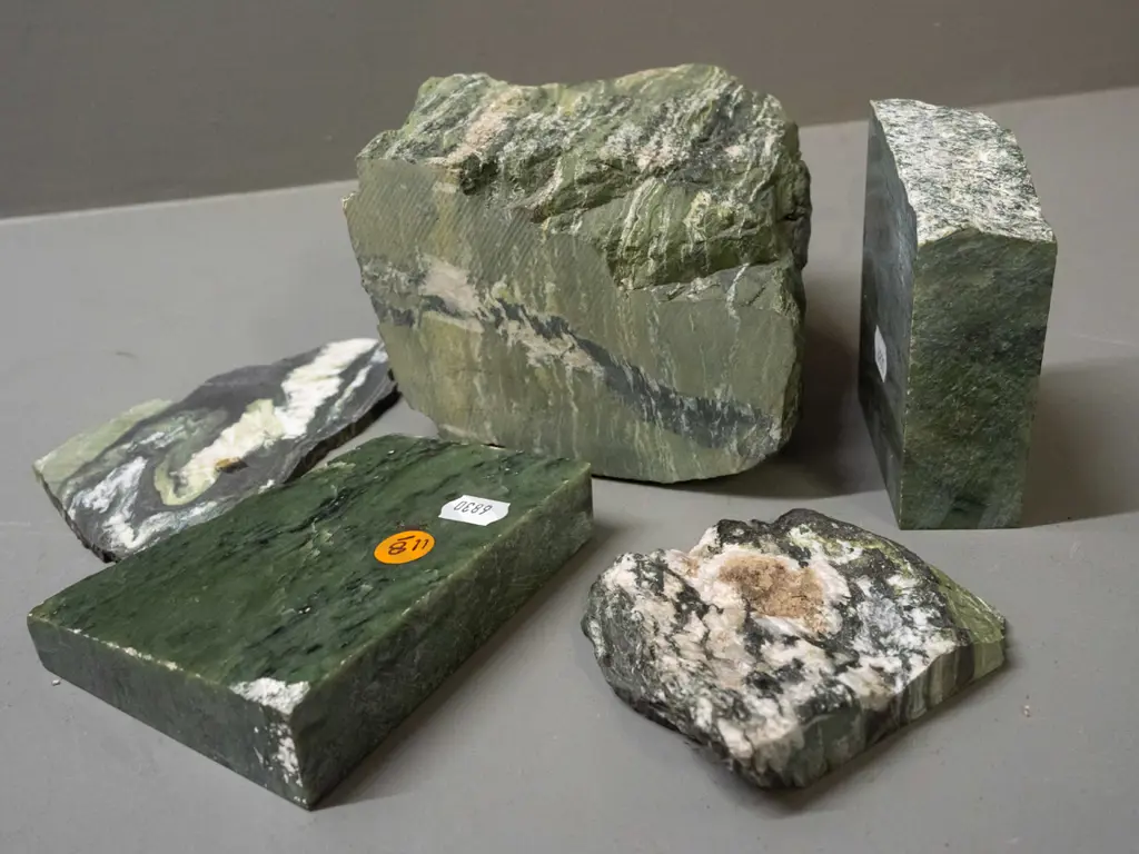 pieces of cut and partly polished stone - green stone with quartz and other veins - one piece has blue paint residue. Image 1++
