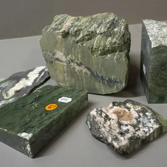 pieces of cut and partly polished stone - green stone with quartz and other veins - one piece has blue paint residue.