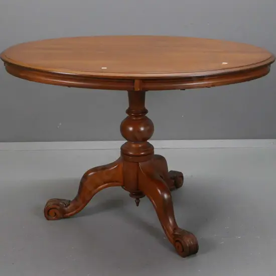 colonial kauri oval-top pedestal-based tea or breakfast table, turned column w/ 3 sweeping legs, swirled carved foliate
