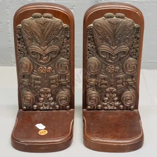 pair of Maori themed (mahogany?) timber book ends with applied cast copper-finish decoration - label on base: Exclusive