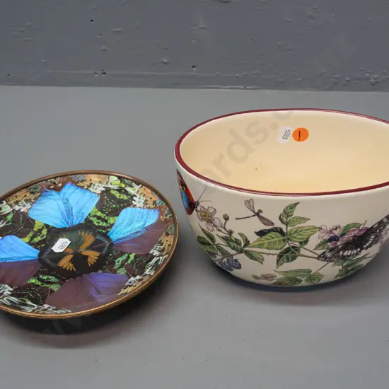 brass dish with iridescent butterfly wing decoration under plastic liner and an oval bowl or planter with berry and
