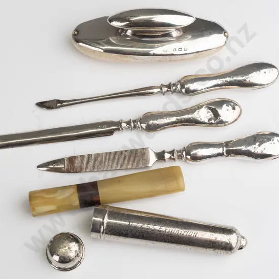 silver manicure set marked with anchor, lion, M & silver pipe mouth piece container with mouth piece engraved from the
