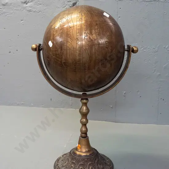 very heavy brass globe on rotating mount and stem, on circular base - globe is incised with script, animal and human