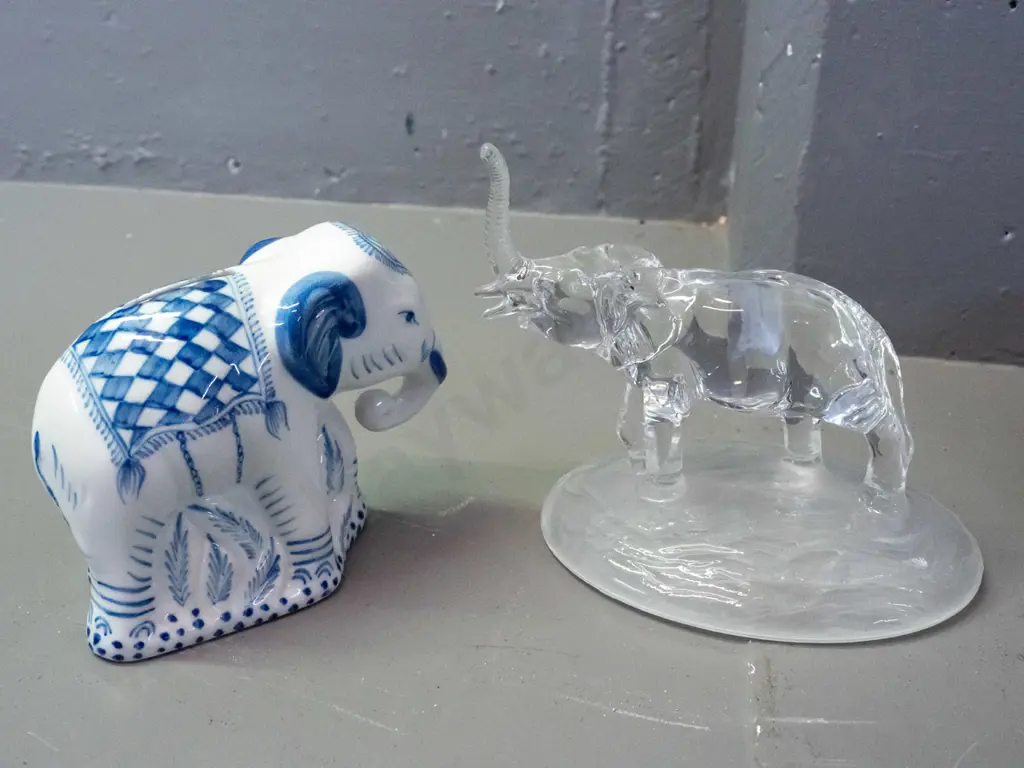 5 ornamental elephants - carved ebony, carved teak, clear glass with frosted base, blue and white coin bank and one Image 1++