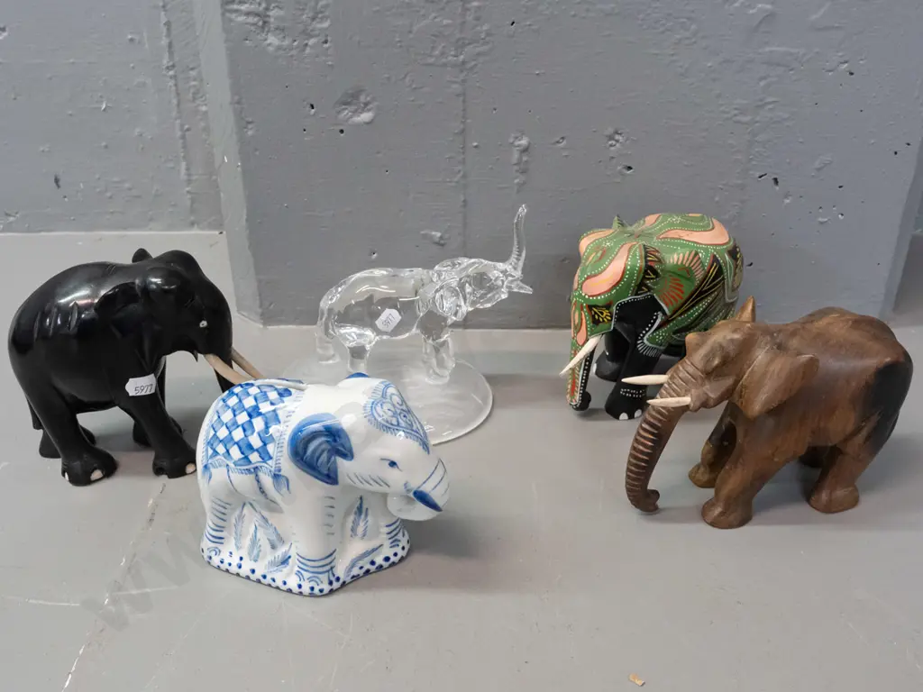 5 ornamental elephants - carved ebony, carved teak, clear glass with frosted base, blue and white coin bank and one Image 1++