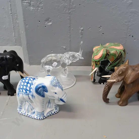 5 ornamental elephants - carved ebony, carved teak, clear glass with frosted base, blue and white coin bank and one