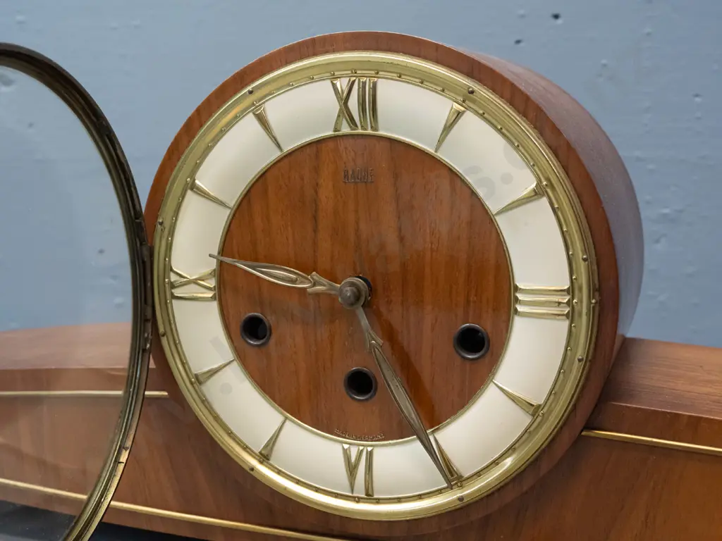 mid-century "Baduf" wood cased mantel clock with teak veneer and applied brass stringing, pressed brass & painted face. Image 1++