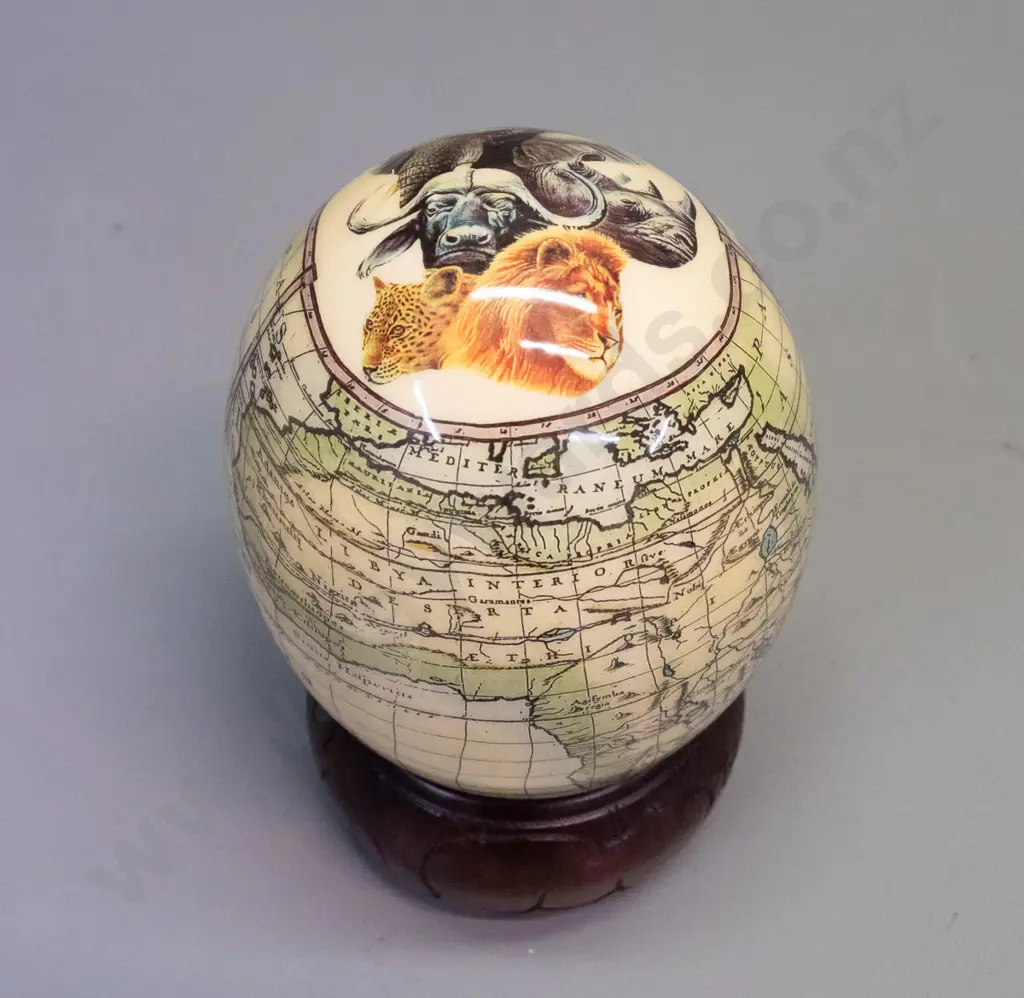 ostrich egg with transfer overlay on African animals and map on carved wood ring base with animal motifs. Combined H-200 Image 1++